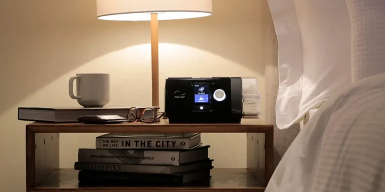 Airsense 10 CPAP machine from Resmed on a nightstand